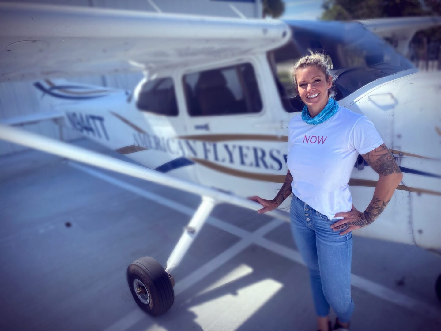 Kelli Darlin standing in front of an airplane.