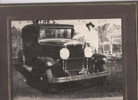 WhatsApp Image 2022-06-28 at 9.55.05 PM A woman standing next to an old car.