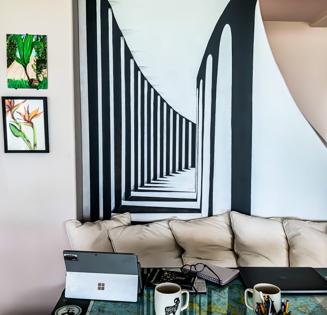 A living room with a couch and two laptops