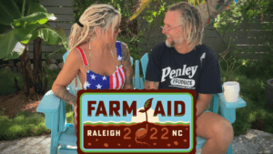 Tony McLean Brown Farm Aid A couple sitting on top of a bench.