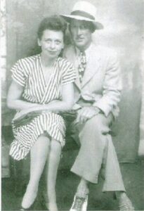 A man and woman sitting on the ground.